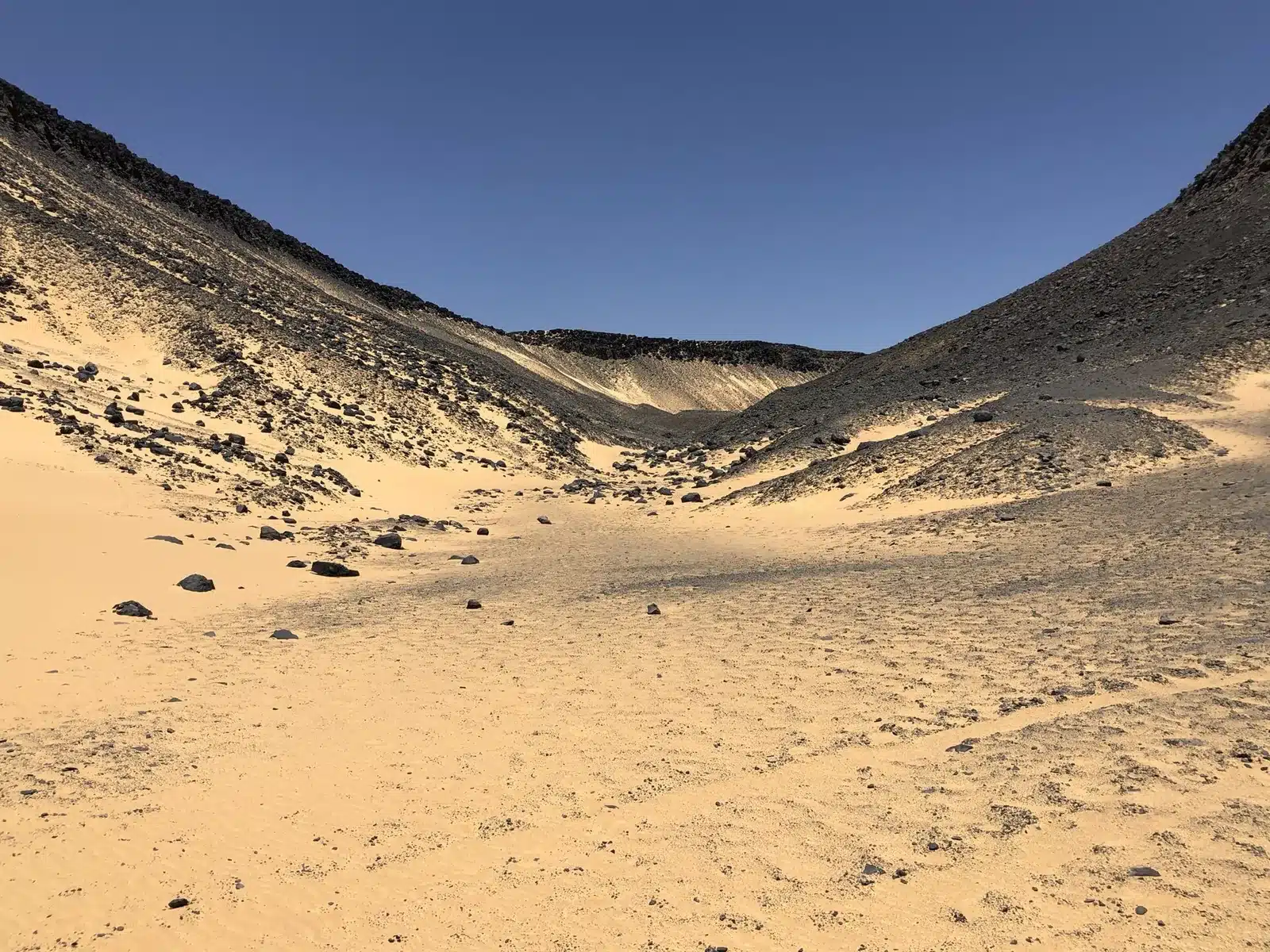 Wide volcanic landscape in the Black Desert of Egypt