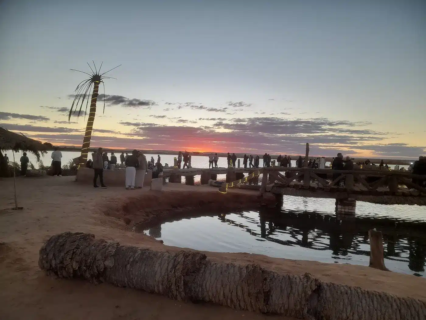 Rustic cafe garden and seating area at Fatnas Island Siwa before sunset