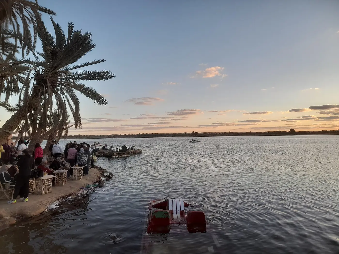 Travelers watching sunset over Lake Siwa from Fatnas Island
