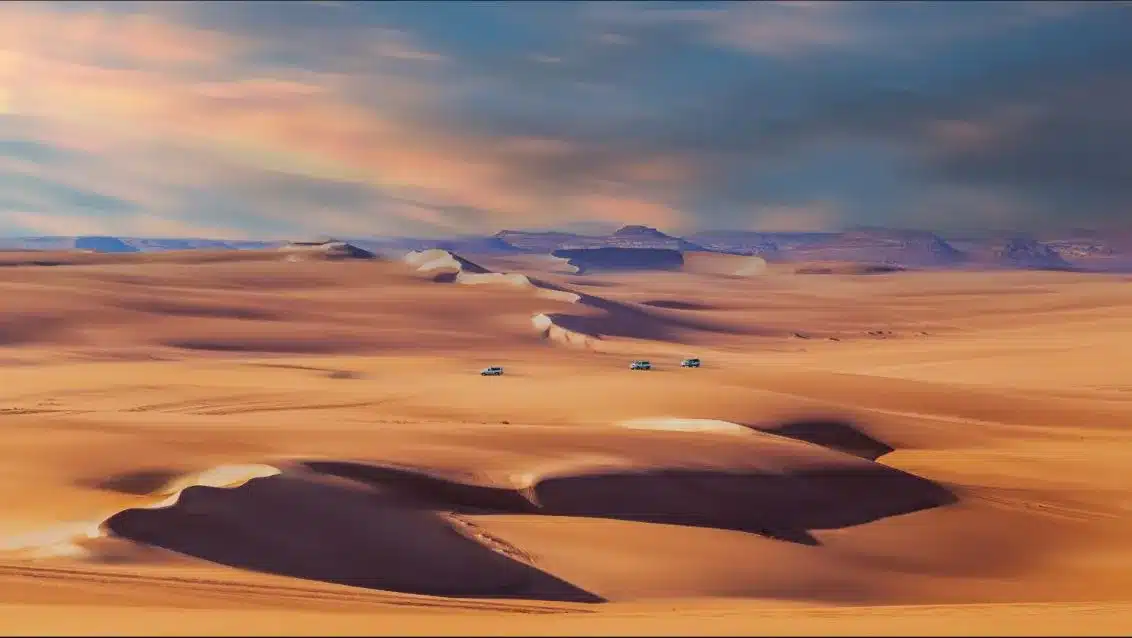 4x4 convoy crossing the Great Sand Sea on a Siwa desert safari