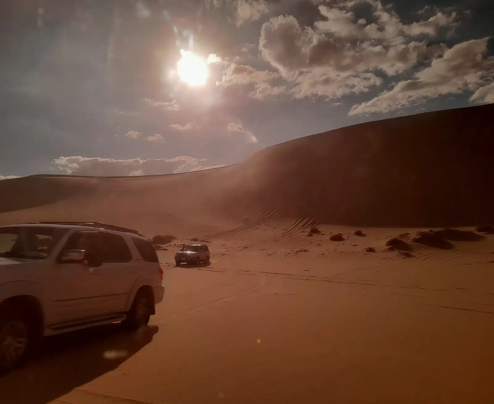 Great Sand Sea dune and private safari vehicles near Siwa Oasis