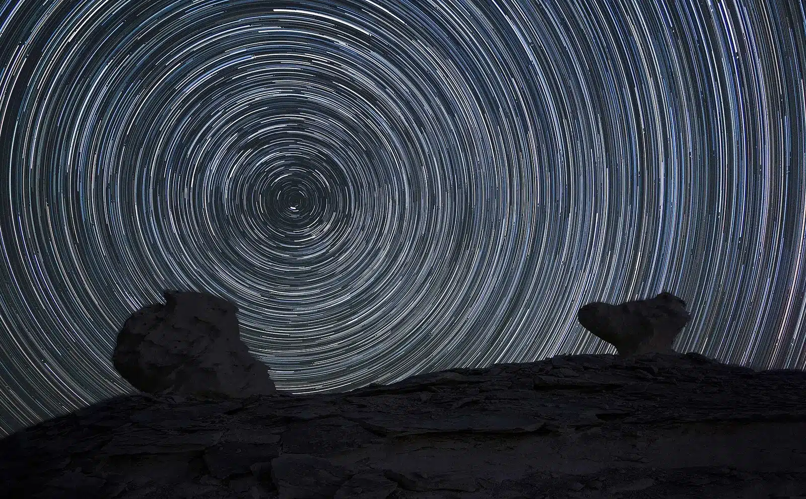 Star trails above a White Desert camping area
