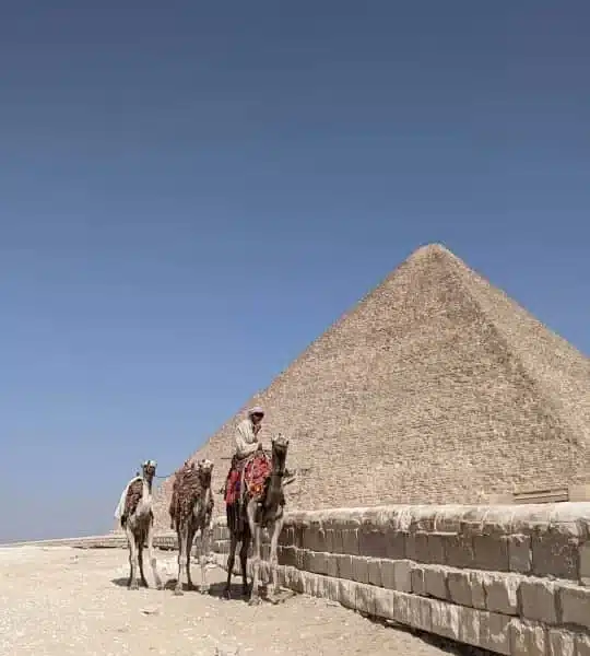 Camel riders beside the Great Pyramid of Giza
