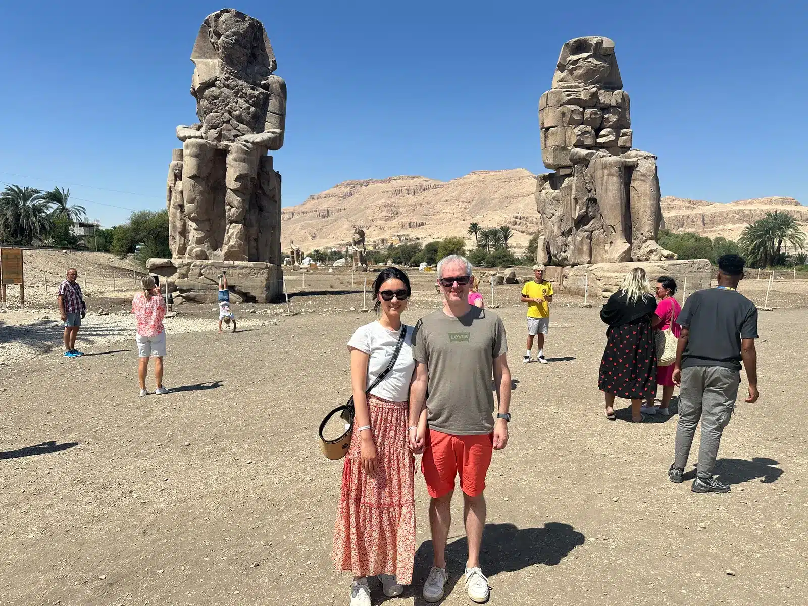 Travelers at the Colossi of Memnon after the road journey from Hurghada