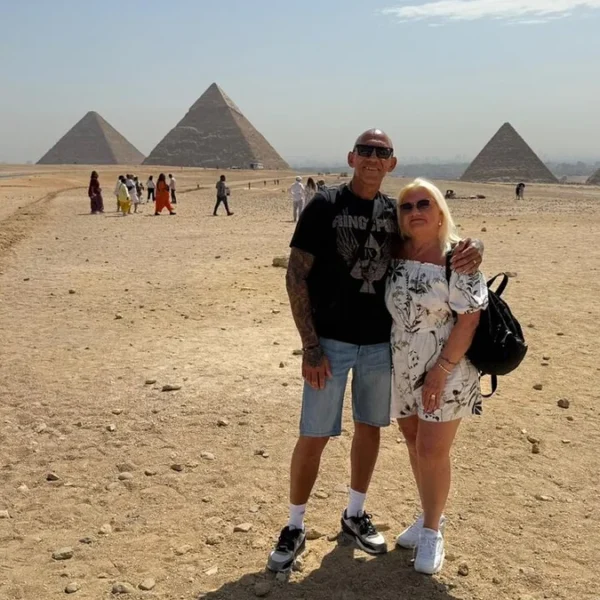 Travelers at the panoramic viewpoint overlooking the Giza Pyramids