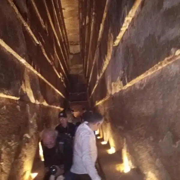 Narrow illuminated passage inside the Great Pyramid of Giza