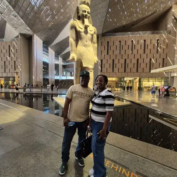 Visitors beside the Ramses II statue in the Grand Egyptian Museum Grand Hall