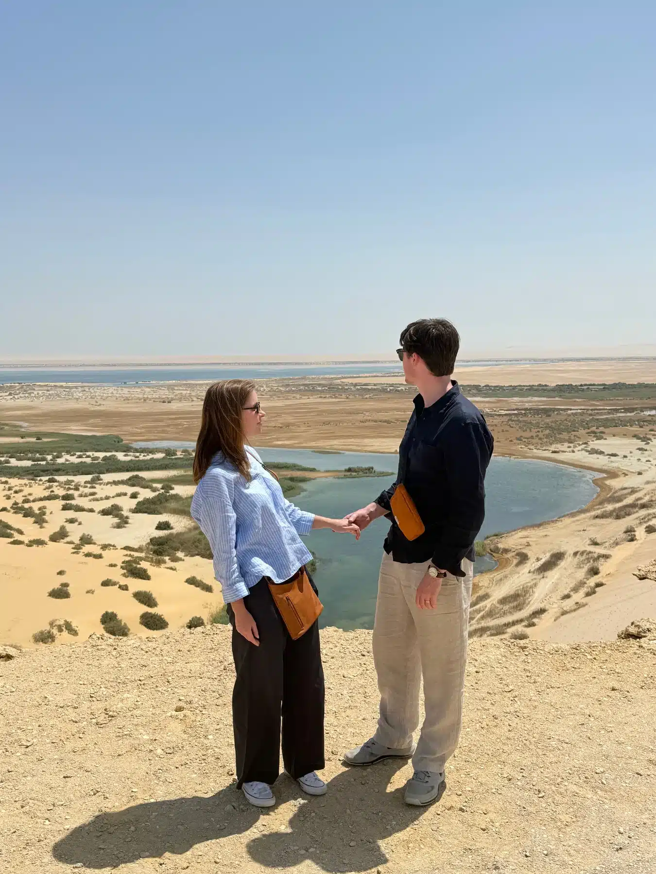 Couple overlooking Magic Lake and the Fayoum desert landscape