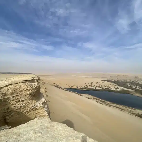 Panoramic view of sand dunes and a desert lake in Fayoum