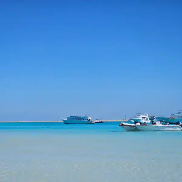 Boats floating on clear turquoise Red Sea water near Hurghada