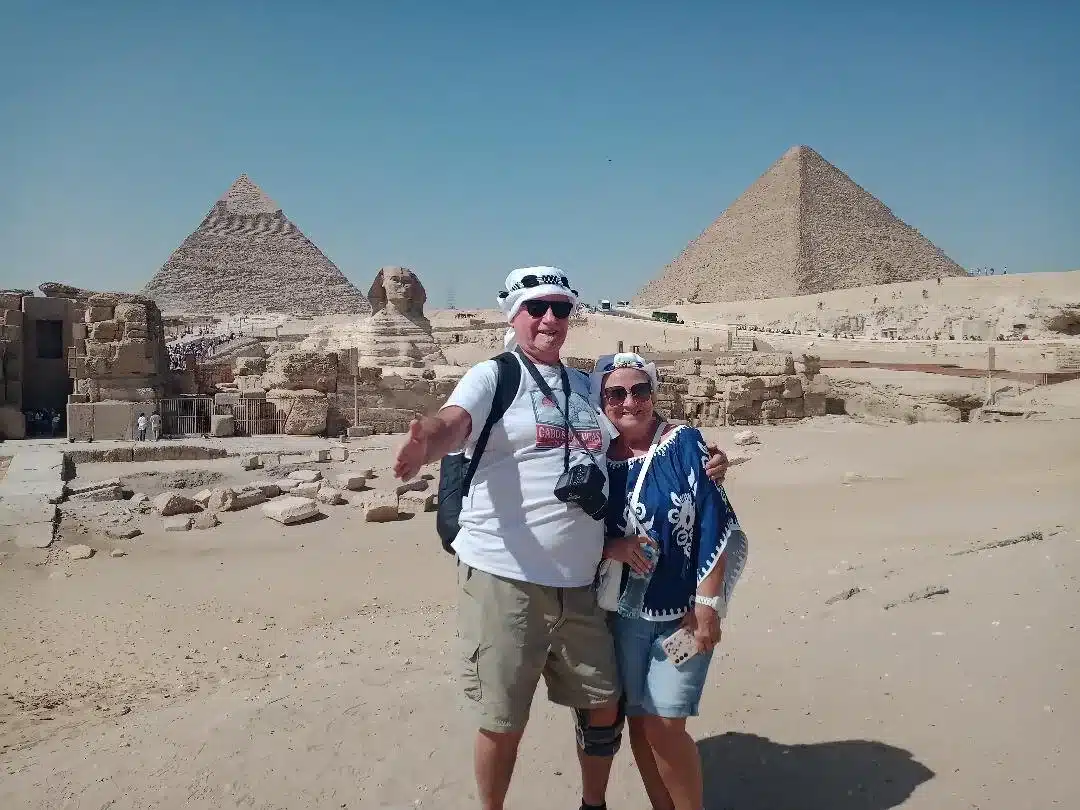Travelers with the Great Sphinx and Giza Pyramids behind them